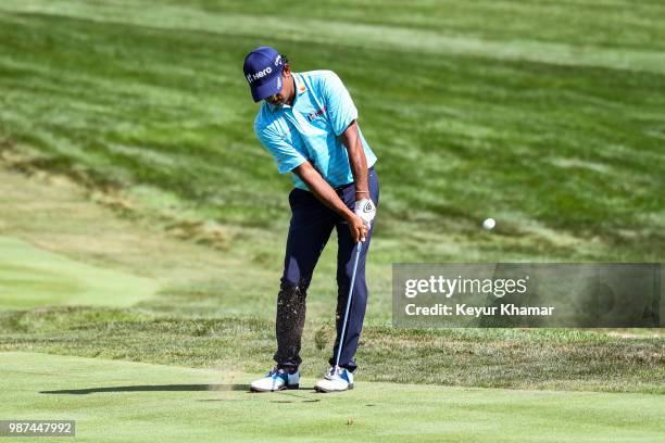 Anirban Lahiri of India chips his third shot to the 18th hole green during the second round of the Quicken Loans National at TPC Potomac at Avenel...