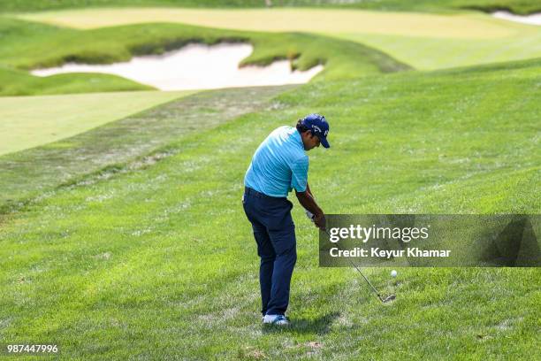 Anirban Lahiri of India hits a shot from the rough on the 18th hole during the second round of the Quicken Loans National at TPC Potomac at Avenel...