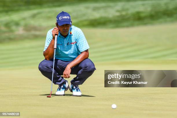 Anirban Lahiri of India reads his par putt on the 18th hole green during the second round of the Quicken Loans National at TPC Potomac at Avenel Farm...