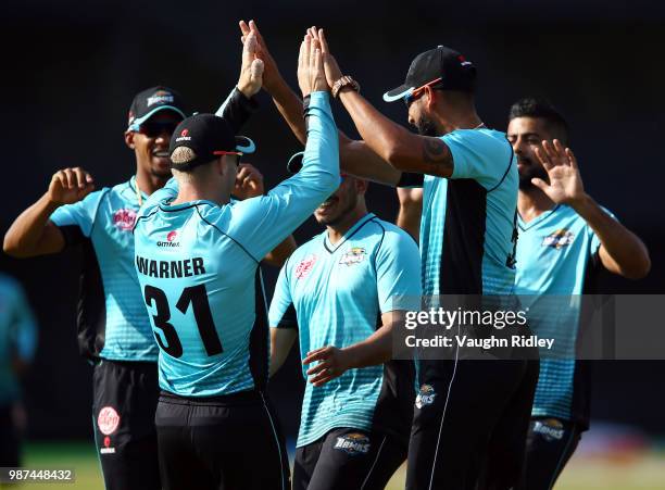 David Warner of Winnipeg Hawks celebrates with teammates after catching Dwayne Smith of Montreal Tigers out during a Global T20 Canada match at Maple...