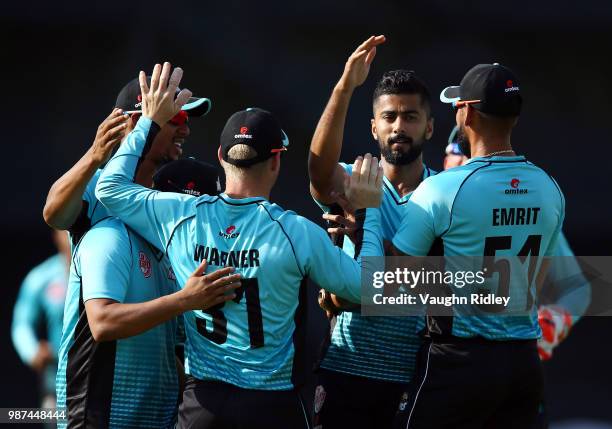 David Warner of Winnipeg Hawks celebrates with teammates after catching Dwayne Smith of Montreal Tigers out during a Global T20 Canada match at Maple...