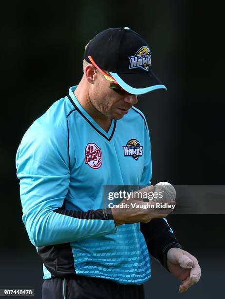 David Warner of Winnipeg Hawks looks at the ball during a Global T20 Canada match against Montreal Tigers at Maple Leaf Cricket Club on June 29, 2018...