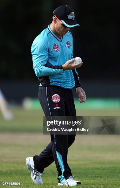 David Warner of Winnipeg Hawks looks at the ball during a Global T20 Canada match against Montreal Tigers at Maple Leaf Cricket Club on June 29, 2018...