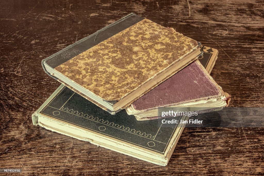 Old and vintage books on grunge wooden table
