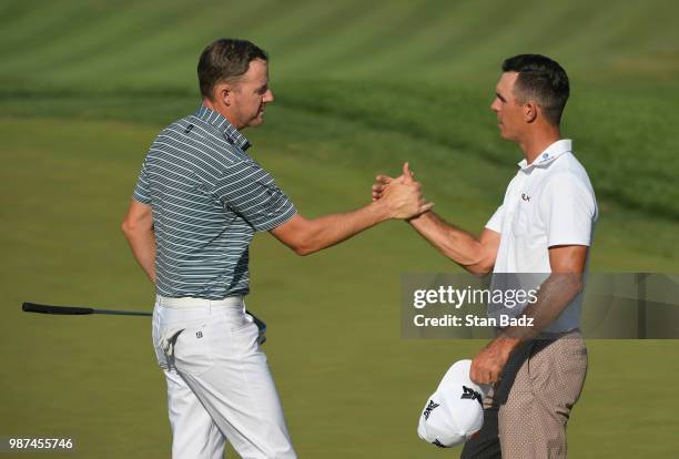 Jimmy Walker and Billy Horschel shake hands on the 18th hole during the second round of the Quicken Loans National at TPC Potomac at Avenel Farm on...