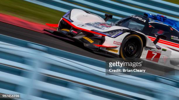 The Acura DPi of Ricky Taylor and Helio Castroneves, of Brazil, races on the track during practice for the Sahlens Six Hours of the Glen IMSA...