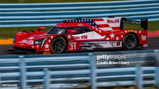The Cadillac DPi of Eric Curran, Felipe Nasr, of Brazil, and Mike Conway, of Great Britain, races on the track during practice for the Sahlens Six...