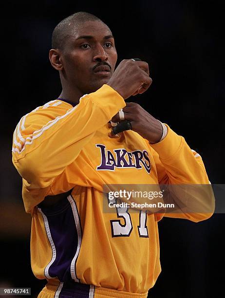 Ron Artest of the Los Angeles Lakers puts on his shirt while taking on the Oklahoma City Thunder during Game Five of the Western Conference...