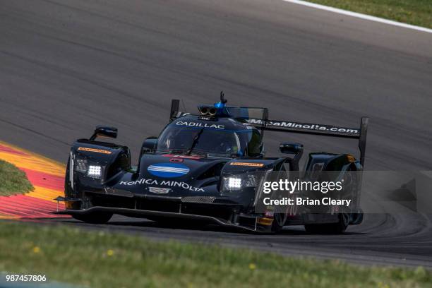 The Cadillac DPi of Jordan Taylor and Renger van der Zande, of the Netherlands, races on the track during practice for the Sahlens Six Hours of the...