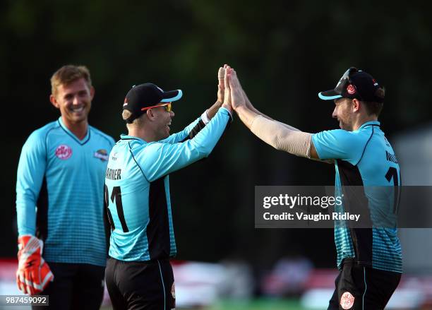 David Warner of Winnipeg Hawks celebrates with David Miller after running out Rayyan Pathan of Montreal Tigers during a Global T20 Canada match at...