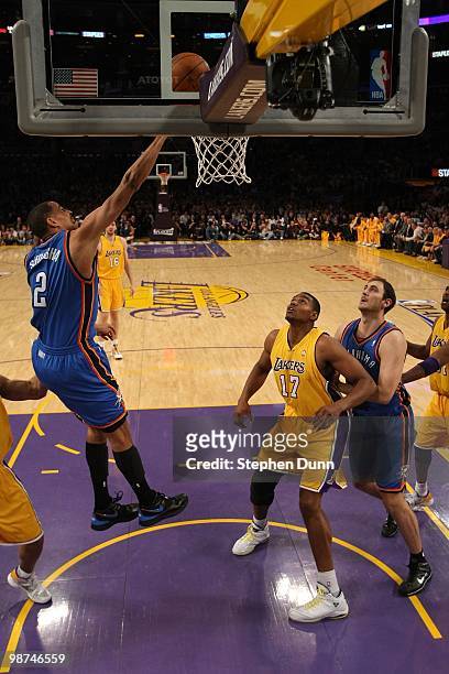 Thabo Sefolosha of the Oklahoma City Thunder lays the ball up as Andrew Bynum of the Los Angeles Lakers watches during Game Five of the Western...