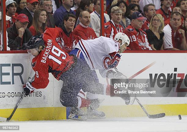 Nicklas Backstrom of the Washington Capitals bounces off Scott Gomez of the Montreal Canadiens in Game Seven of the Eastern Conference Quarterfinals...