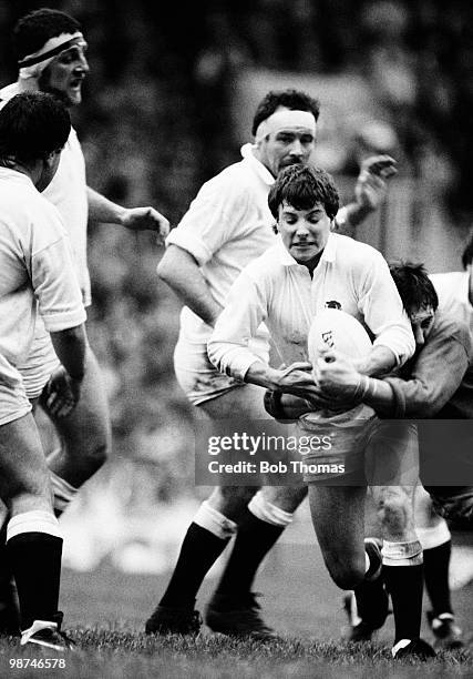 Rob Andrew of England is held by Welsh number 8 Phil Davies during the Rugby Union International match held at Twickenham, London on 18th January...