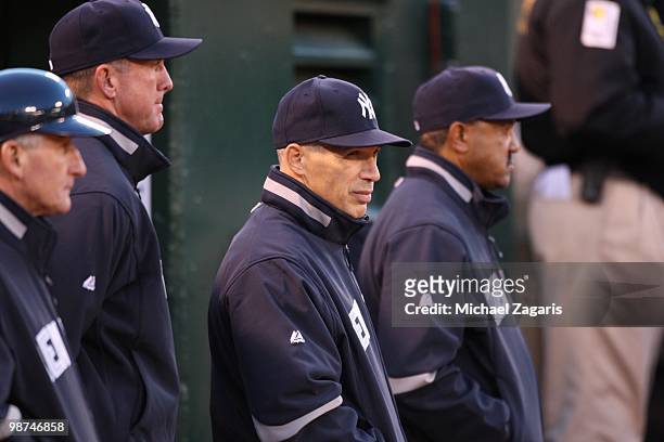Manager Joe Girardi of the New York Yankees standing with the Yankees coaches during the game against the Oakland Athletics at the Oakland Coliseum...
