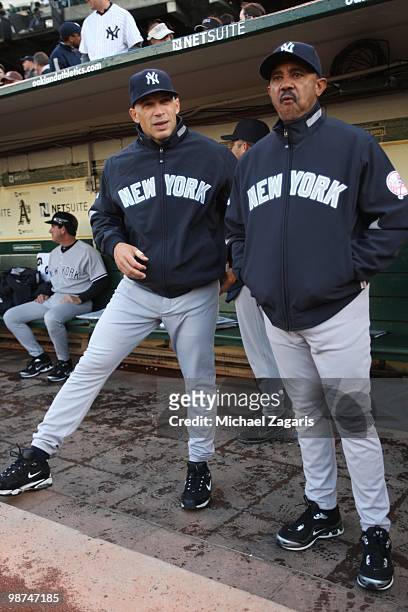 Manager Joe Girardi and Bench Coach Tony Pena of the New York Yankees standing in the dugout prior to the game against the Oakland Athletics at the...