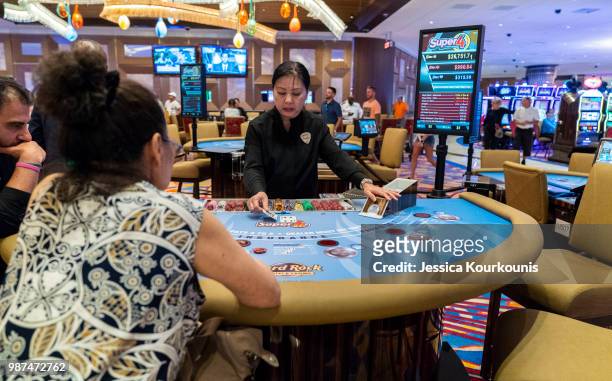 Patrons gamble inside the Hard Rock Hotel and Casino, previously the Trump Taj Mahal, on June 29, 2018 in Atlantic City, New Jersey. The Hard Rock is...