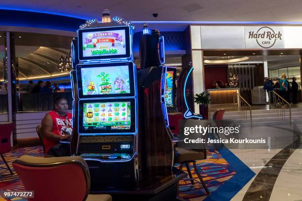 Patrons gamble inside the Hard Rock Hotel and Casino, previously the Trump Taj Mahal, on June 29, 2018 in Atlantic City, New Jersey. The Hard Rock is...