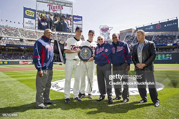 Joe Mauer of the Minnesota Twins poses with the 2009 AL MVP Award with Tony Oliva, Justin Morneau, Harmon Killebrew, Rod Carew and Chuck Schupp of...