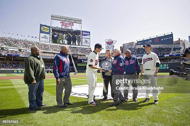 Former Twin Harmon Killebrew presents Joe Mauer of the Minnesota Twins with the 2009 AL MVP Award with La Velle Neal III, Tony Oliva, Chuck Schupp of...