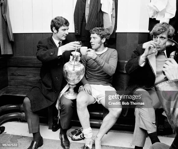Brian Labone and Alan Ball of Everton raise a toast to the First Division Championship trophy in the dressing room at Goodison Park after a 2-0...