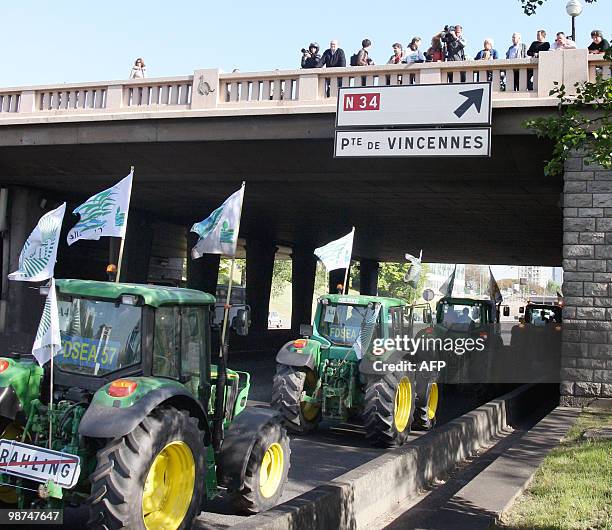 French farmers drive their tractors on Paris ring road, near the Porte de Vincennes area, on April 27, 2010 before demonstrating in Paris against...