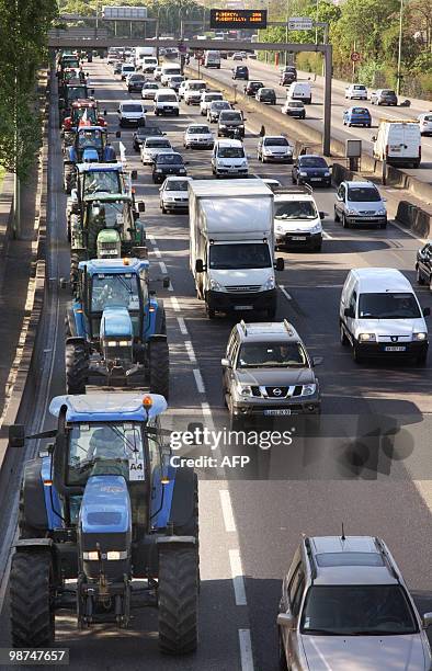 French farmers drive their tractors on Paris ring road, near the Porte de Vincennes area, on April 27, 2010 before demonstrating in Paris against...