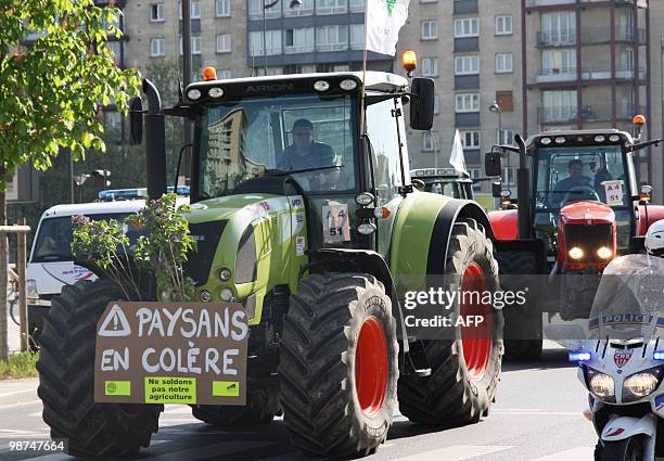 French farmers drive their tractors in Paris on April 27, 2010 before demonstrating against wages cut and to denounce the European Farm Policy. The...