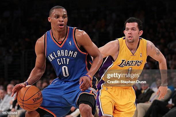 Russell Westbrook of the Oklahoma City Thunder drives on Jordan Farmar of the Los Angeles Lakers during Game Five of the Western Conference...