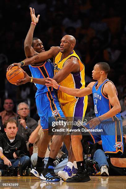 Lamar Odom of the Los Angeles Lakers passes the ball between Serge Ibaka and Russell Westbrook of the Oklahoma City Thunder during Game Five of the...