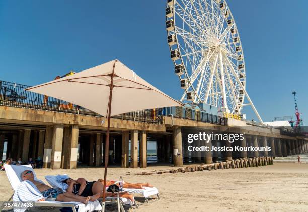 Visitors lounge on the beach on June 29, 2018 in Atlantic City, New Jersey. Two new casinos opened this week in the seaside resort, as residents seek...