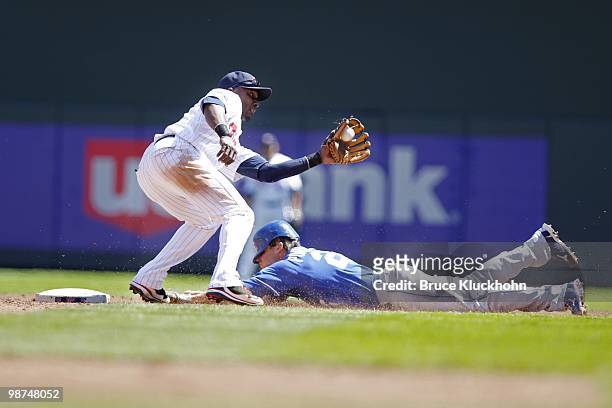 Orlando Hudson of the Minnesota Twins catches the ball as Scott Podsednik of the Kansas City Royals steals second base on April 18, 2010 at Target...