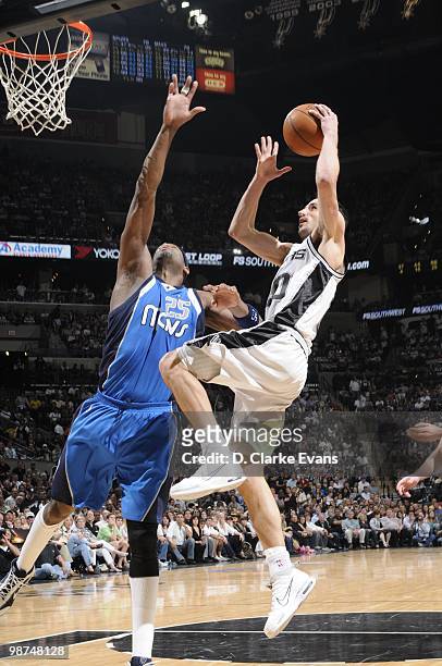 Manu Ginobili of the San Antonio Spurs jumps to the basket for a layup against Erick Dampier of the Dallas Mavericks in Game Three of the Western...