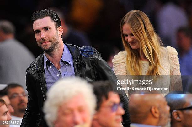 Singer Adam Levine and model Anne V walk behind the courtside seats during Game Five of the Western Conference Quarterfinals of the 2010 NBA Playoffs...