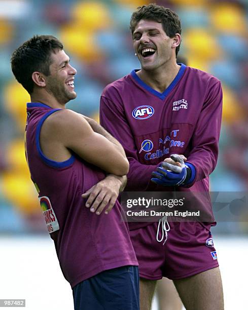 Chris Johnson and Darryl White of the Brisbane Lions share a joke during training in preperation for the Lions round 9 AFL match against the Adelaide...