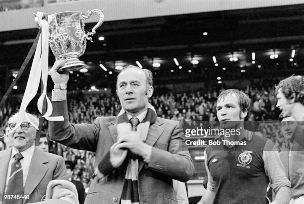 Aston Villa manager Ron Saunders holding the trophy aloft watched by his captain Ian Ross after their 1-0 victory over Norwich City in the Football...