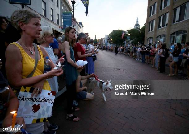 People line up on both sides of Main St. During a candlelight vigil to honor the 5 people were shot and killed at the Capital Gazette newpaper...