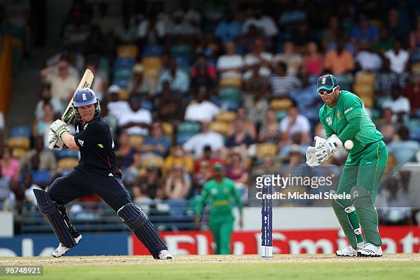 Eoin Morgan of England hits to the offside as Mark Boucher looks on during the ICC T20 World Cup warm up match between South Africa and England on...