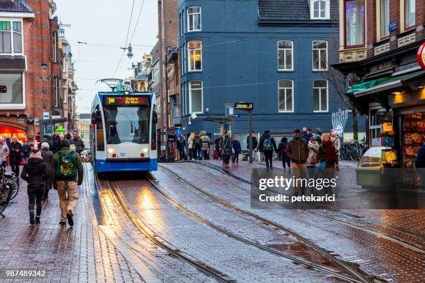 verkehr auf einer straße in amsterdam - netherlands red light district stock-fotos und bilder