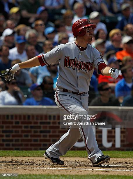 Adam LaRoche of the Arizona Diamondbacks follows the flight of his three-run home run in the 4th inning against the Chicago Cubs at Wrigley Field on...