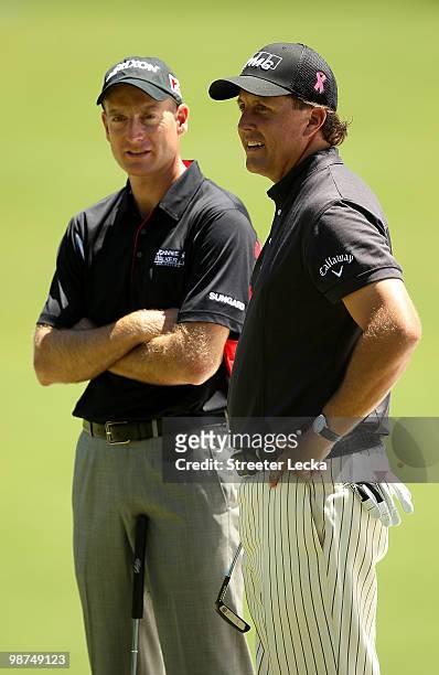 Jim Furyk and Phil Mickelson talk as they wait on the 4th green during the first round of the Quail Hollow Championship at Quail Hollow Country Club...