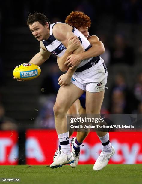 Patrick Dangerfield of the Cats is tackled by Ed Richards of the Bulldogs during the 2018 AFL round 15 match between the Western Bulldogs and the...
