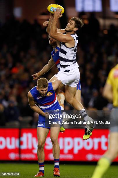 Tom Hawkins of the Cats takes a big mark over Jackson Trengove and Hayden Crozier of the Bulldogs during the 2018 AFL round 15 match between the...