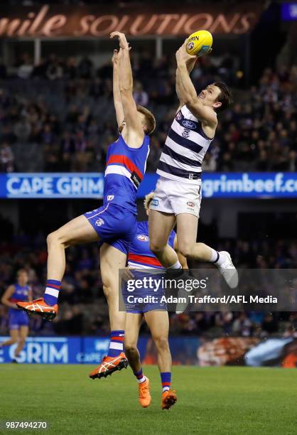 Patrick Dangerfield of the Cats marks the ball over Jackson Trengove of the Bulldogs during the 2018 AFL round 15 match between the Western Bulldogs...