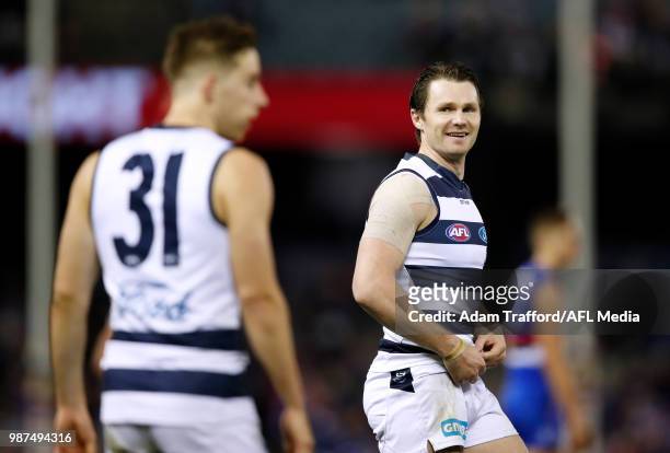 Patrick Dangerfield of the Cats smiles at Jordan Cunico of the Cats during the 2018 AFL round 15 match between the Western Bulldogs and the Geelong...