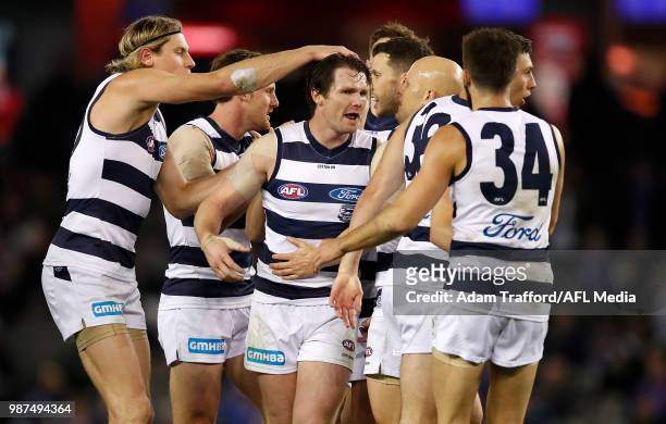 Patrick Dangerfield of the Cats celebrates a goal with teammates during the 2018 AFL round 15 match between the Western Bulldogs and the Geelong Cats...