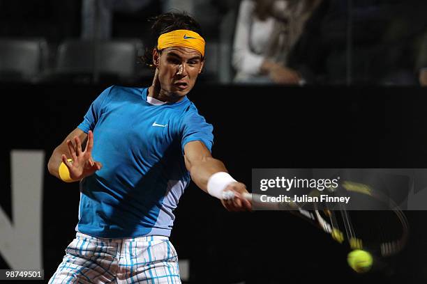 Rafael Nadal of Spain plays a forehand in his match against Victor Hanescu of Romania during day five of the ATP Masters Series - Rome at the Foro...