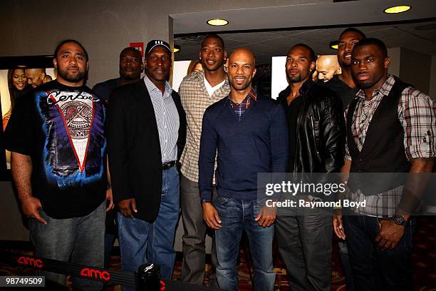 Rapper and actor Common poses for photos with Chicago Bears football players Matt Toeaina, Israel Idonije, Otis Wilson , basketball player and...