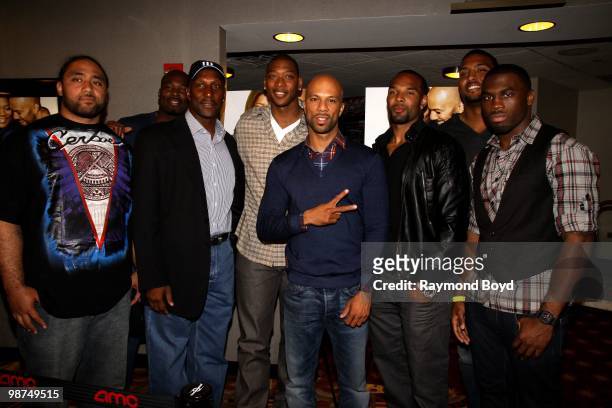 Rapper and actor Common poses for photos with Chicago Bears football players Matt Toeaina, Israel Idonije, Otis Wilson , basketball player and...