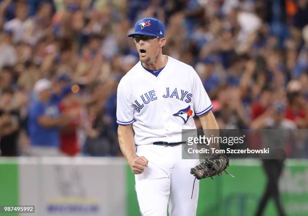 Tyler Clippard of the Toronto Blue Jays celebrates their victory after getting the final out of the game in the ninth inning during MLB game action...