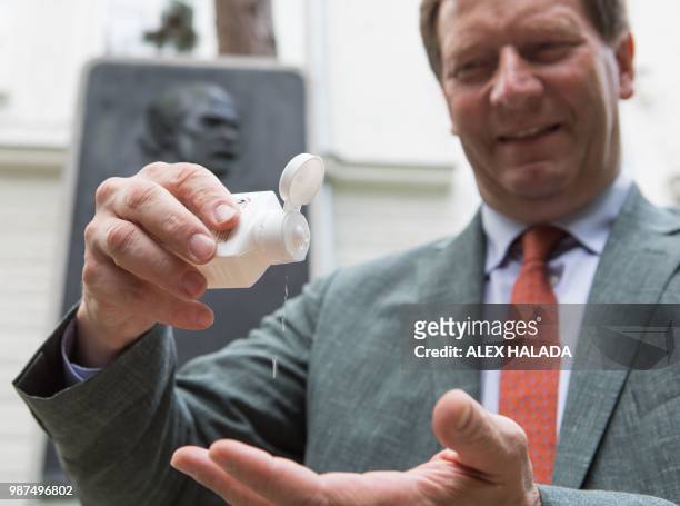 Bernhard Kuenburg, president of the Semmelweis Foundation, demonstrates the use of disinfectants in front of a commemorative plaque for pioneering...